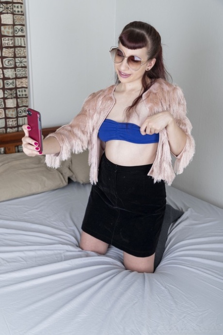 Small-titted babe Calliope probing her hairy pussy with a finger up close