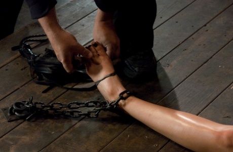 Blonde Rain DeGrey gets her nipples pulled while chained down on the floor